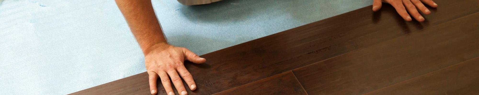 person installing flooring planks